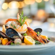 A beautifully plated summer dish with fresh seafood and seasonal ingredients displayed in an elegant fine dining restaurant